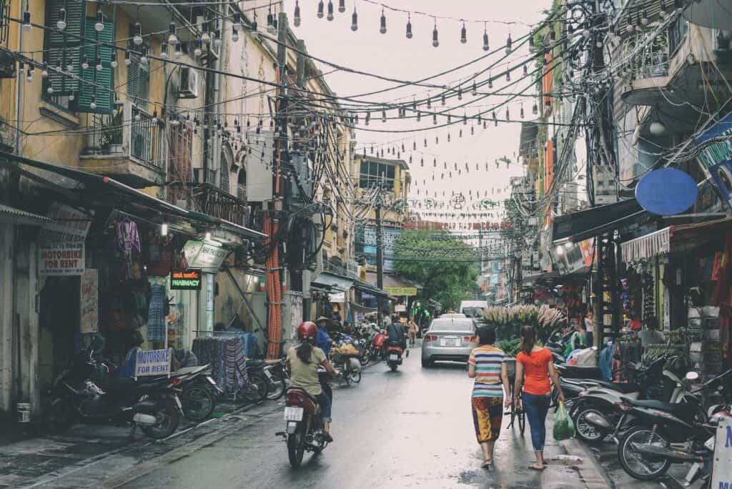 People walking along a street in Hanoi, Vietnam in cool December weather