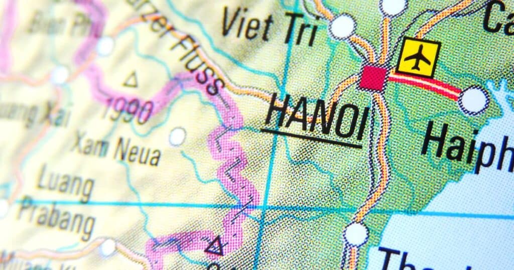Close-up of a map highlighting Hanoi, the capital of Vietnam, with surrounding geographical features and network of roads, marked by a yellow plane symbol indicating the city's main airport.