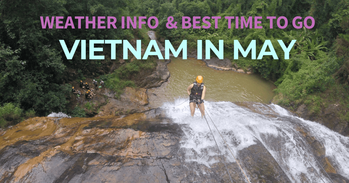 The image features an adventurer rappelling down a waterfall in a lush, green forest as part of a group activity, overlaid with bold text stating "WEATHER INFO & BEST TIME TO GO VIETNAM IN MAY." This suggests an informative theme about the optimal time for traveling to Vietnam with an emphasis on outdoor adventures.
